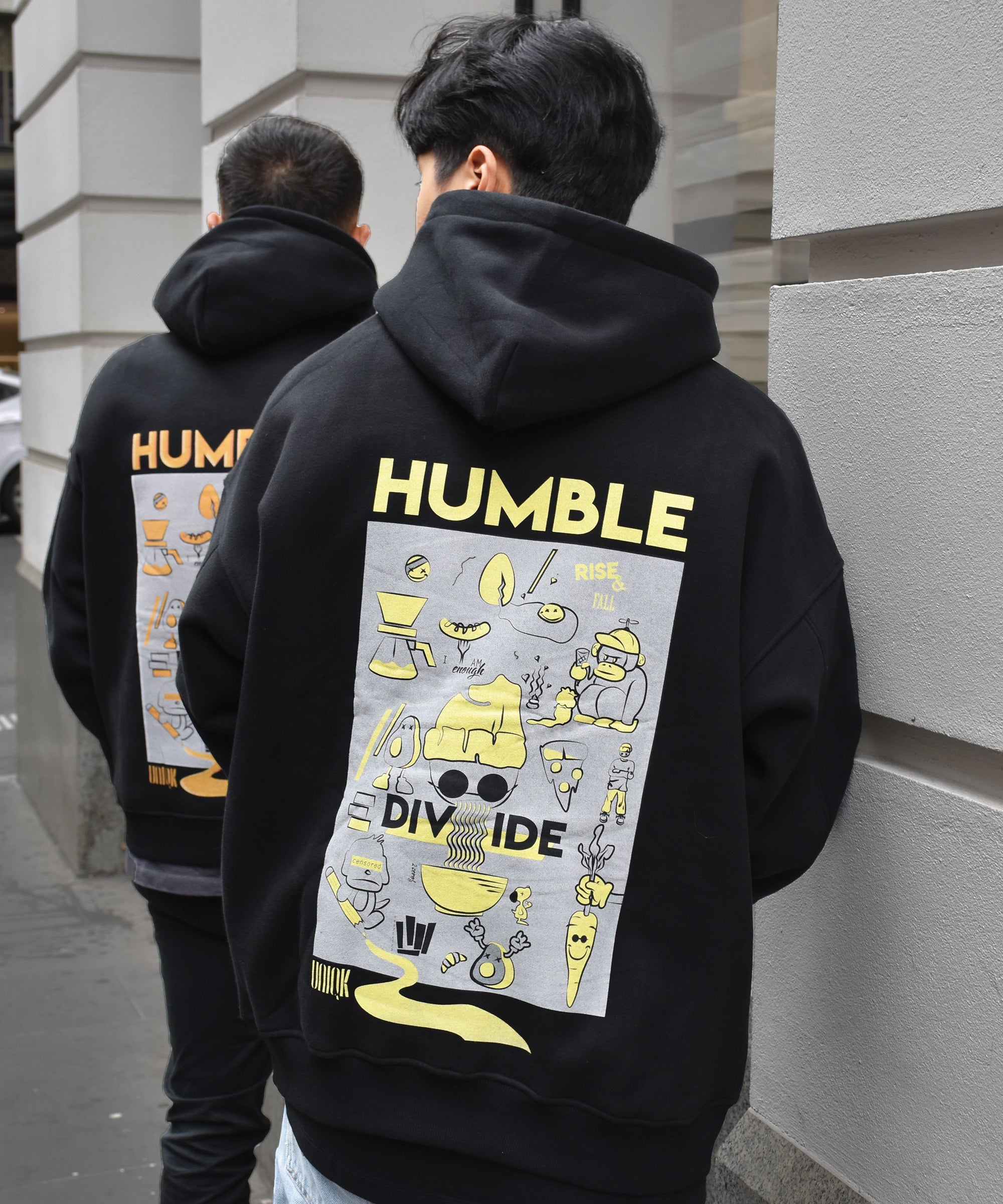 UNIQK 600gsm Melbourne Artwork Oversized Hoodie Black Orange and Yellow 100% Cotton Fleece Male Models Back Pose In city